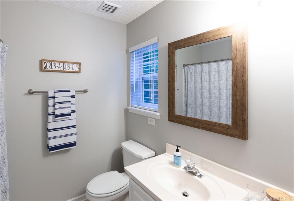8304 Rudolph Road Charlotte, NC 28216 - Photo 14 of 17 a bathroom with a sink a toilet and mirror