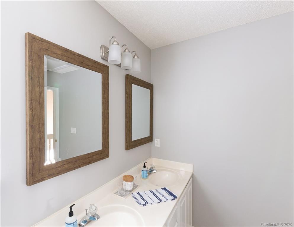 8304 Rudolph Road Charlotte, NC 28216 - Photo 15 of 17 a bathroom with a sink and a mirror