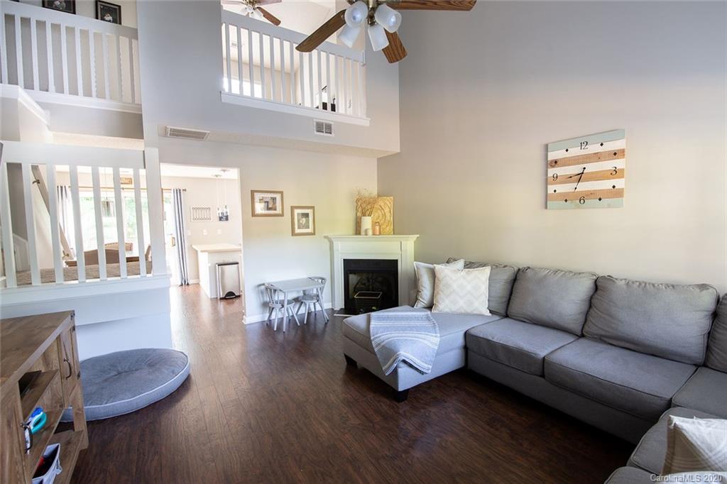 8304 Rudolph Road Charlotte, NC 28216 - Photo 3 of 17 a living room with furniture a fireplace and a chandelier