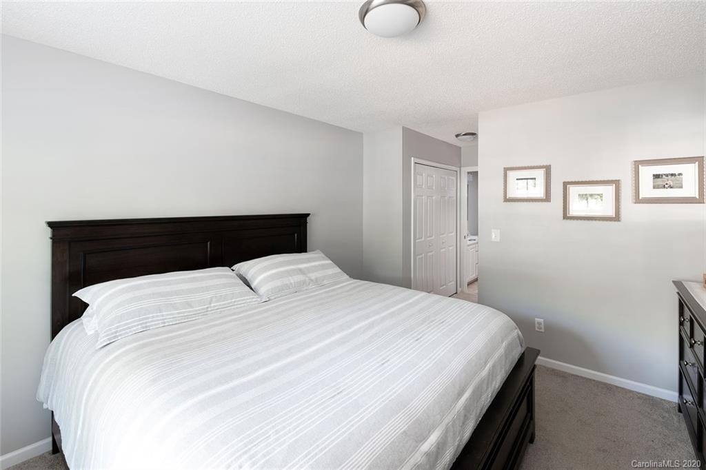 8304 Rudolph Road Charlotte, NC 28216 - Photo 5 of 17 a bedroom with a bed and night stand