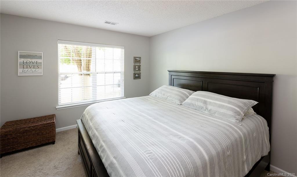 8304 Rudolph Road Charlotte, NC 28216 - Photo 6 of 17 a large bed sitting in a bedroom next to a window