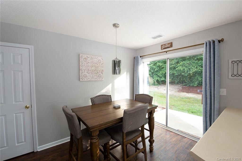 8304 Rudolph Road Charlotte, NC 28216 - Photo 9 of 17 a view of a dining room with furniture window and wooden floor