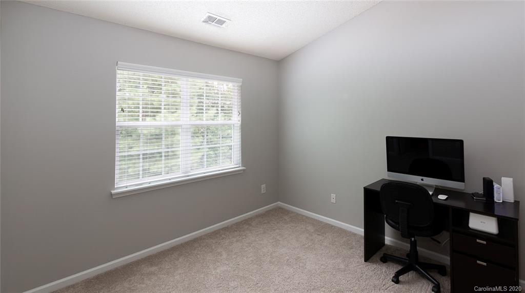 8304 Rudolph Road Charlotte, NC 28216 - Photo 10 of 17 a view of a workspace with furniture and a window