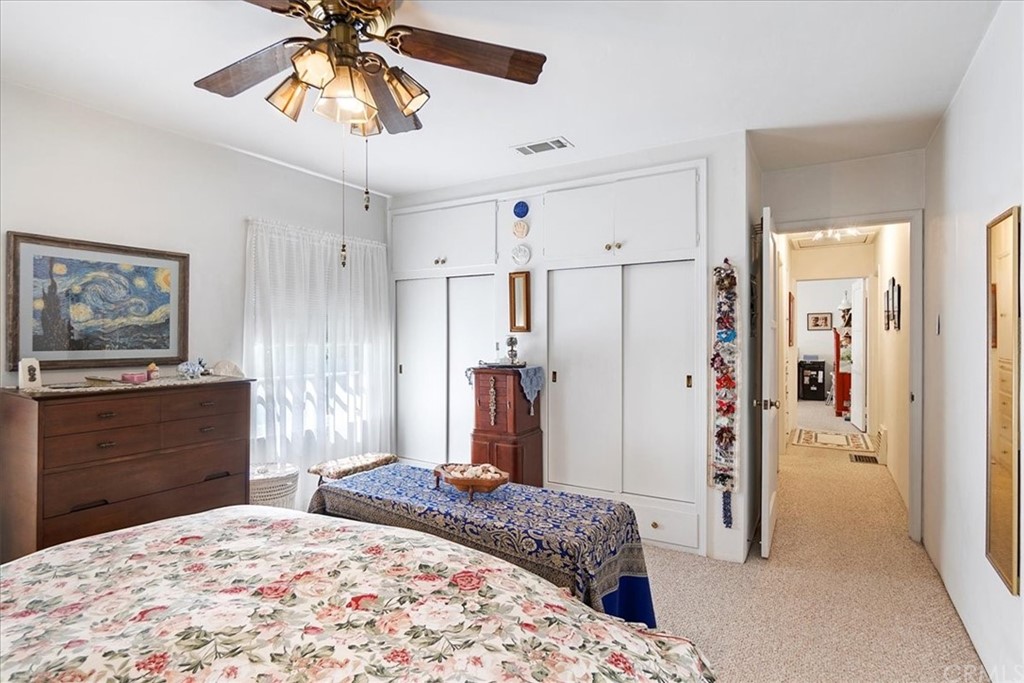 876 North 1st Avenue Upland, CA 91786 - Photo 11 of 30 a bedroom with a bed and a chandelier