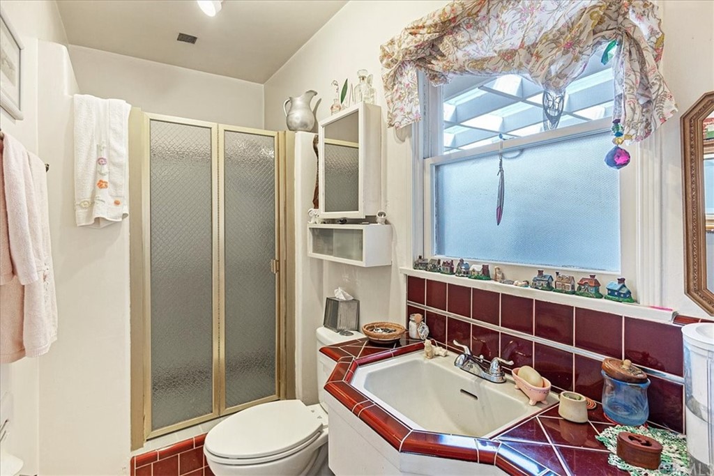 876 North 1st Avenue Upland, CA 91786 - Photo 16 of 30 a bathroom with a sink toilet a mirror and shower