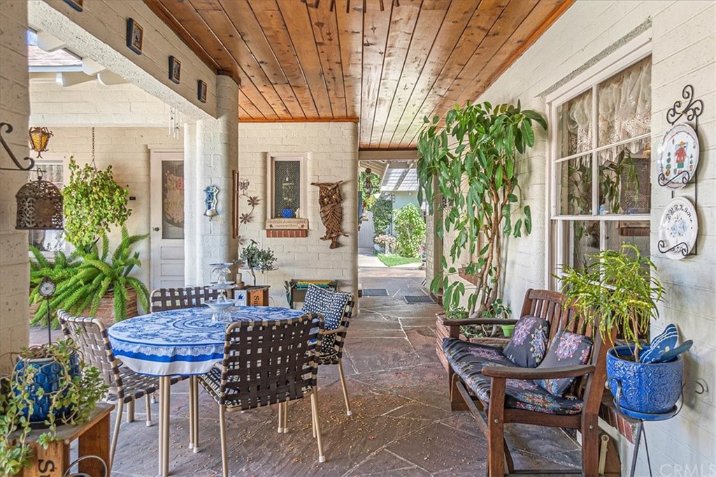 876 North 1st Avenue Upland, CA 91786 - Photo 18 of 30 a view of a patio with table and chairs potted plants and wooden floor