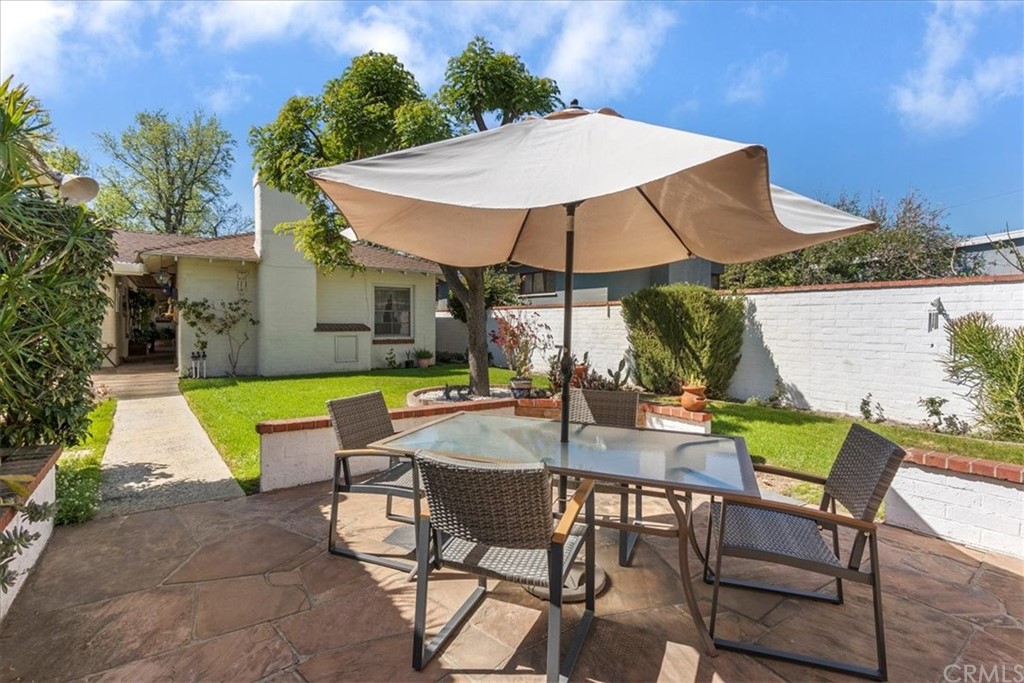 876 North 1st Avenue Upland, CA 91786 - Photo 26 of 30 a view of patio with chairs and table under an umbrella