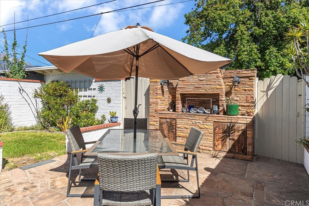 876 North 1st Avenue Upland, CA 91786 - Photo 27 of 30 a view of backyard of house with seating space and trees