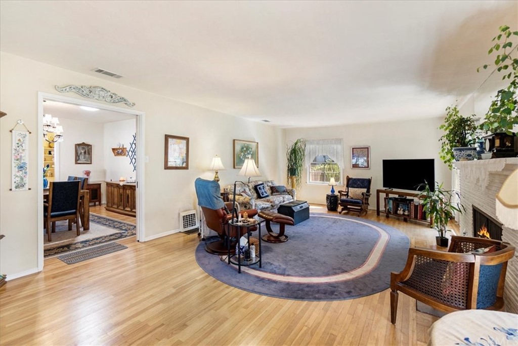 876 North 1st Avenue Upland, CA 91786 - Photo 5 of 30 a living room with furniture a dining table and a flat screen tv