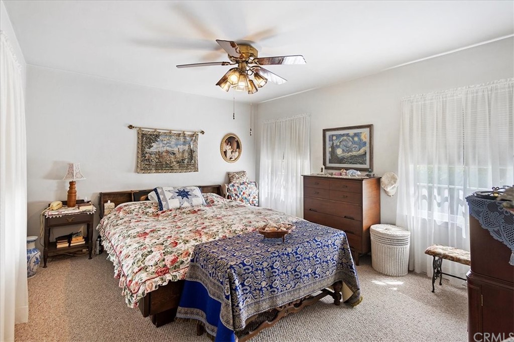 876 North 1st Avenue Upland, CA 91786 - Photo 10 of 30 a bedroom with a bed and a chandelier