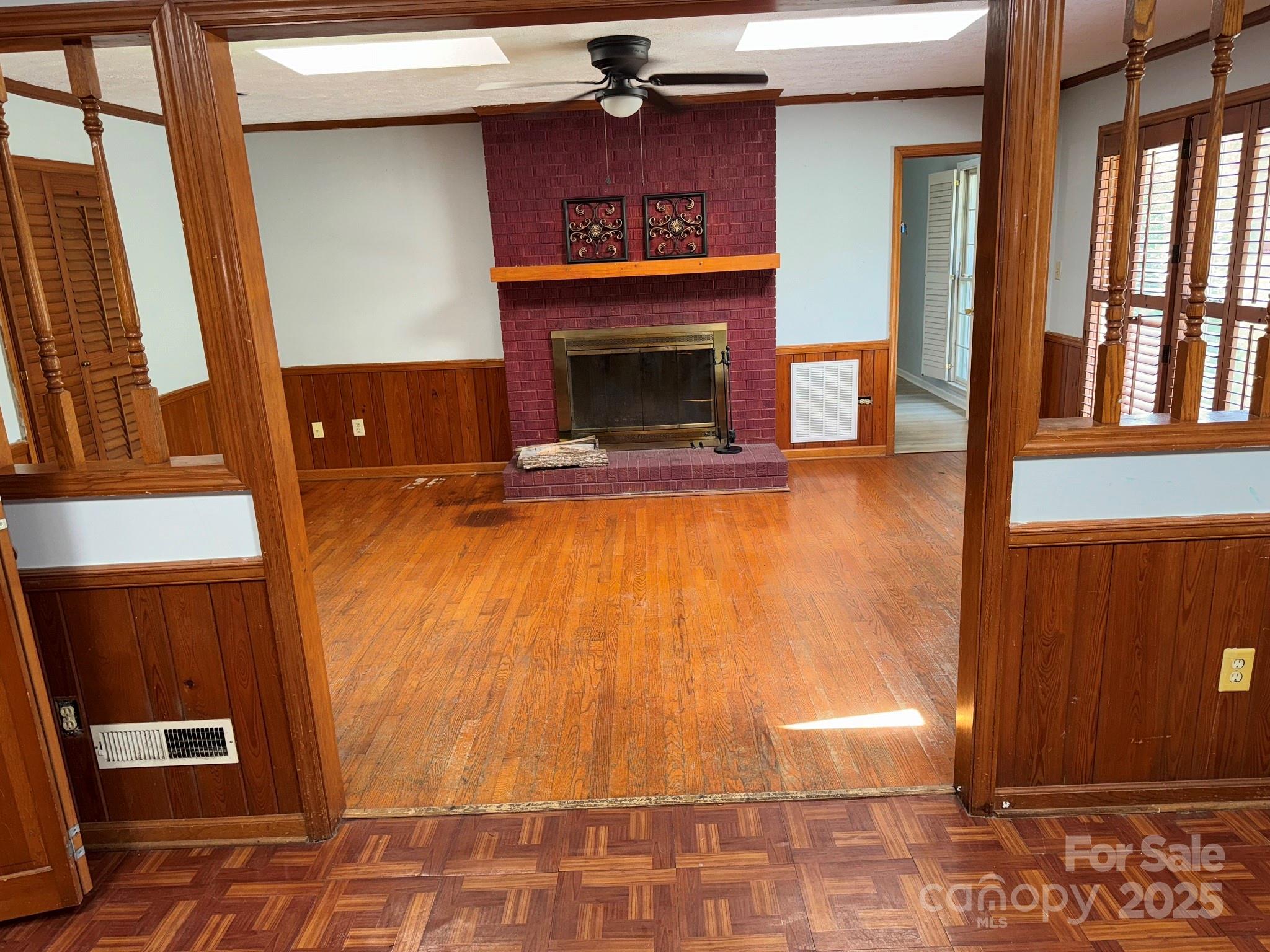 802 Roberdell Road Rockingham, NC 28379 - Photo 13 of 43 a view of an empty room with wooden floor and a fireplace