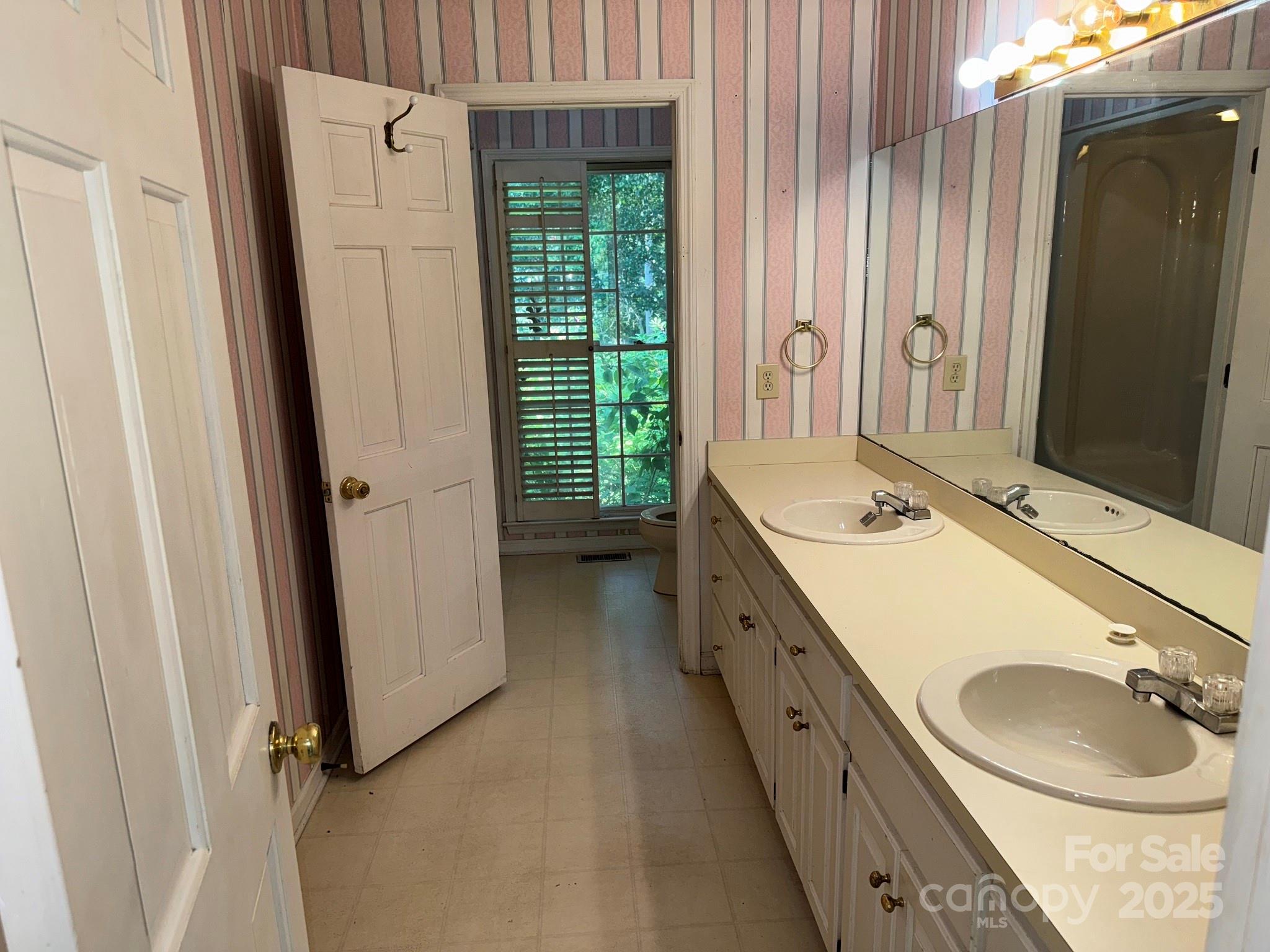 802 Roberdell Road Rockingham, NC 28379 - Photo 15 of 43 a bathroom with a double vanity sink and mirror with bathtub