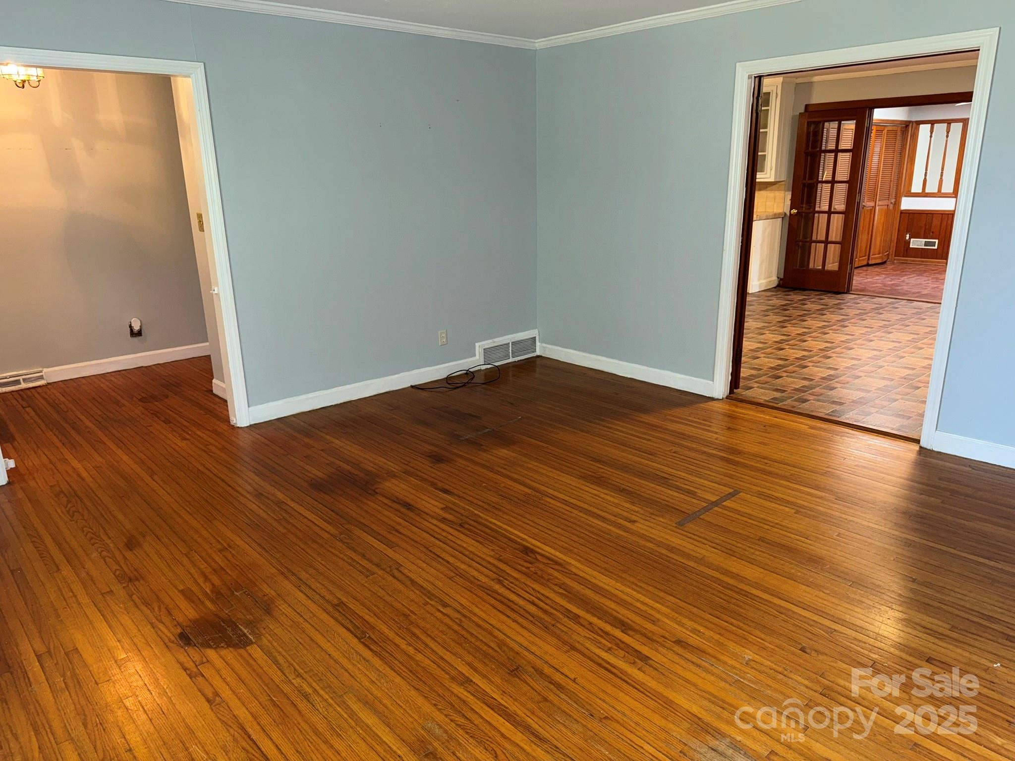 802 Roberdell Road Rockingham, NC 28379 - Photo 24 of 43 an empty room with wooden floor and windows