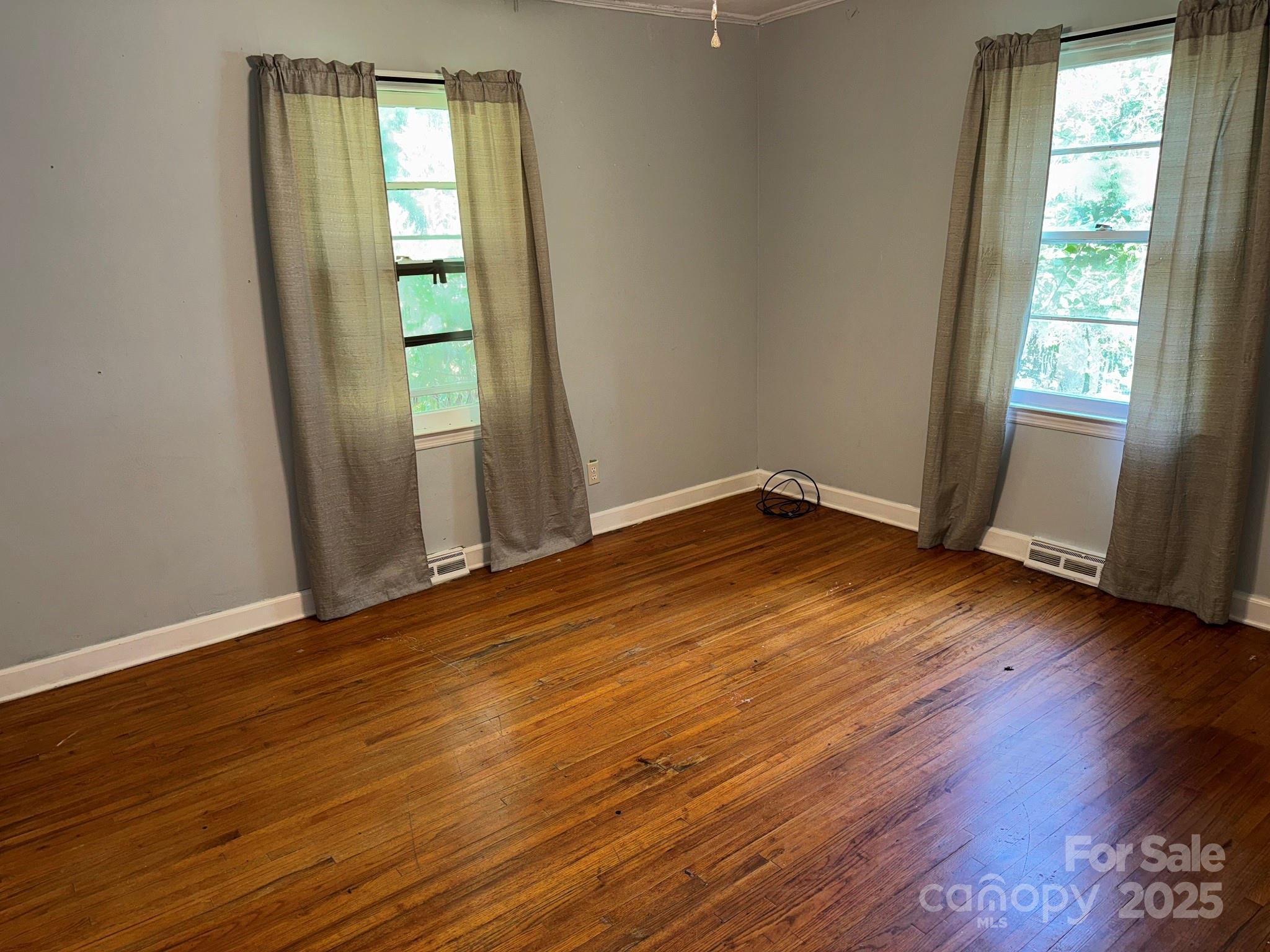 802 Roberdell Road Rockingham, NC 28379 - Photo 27 of 43 an empty room with wooden floor and windows