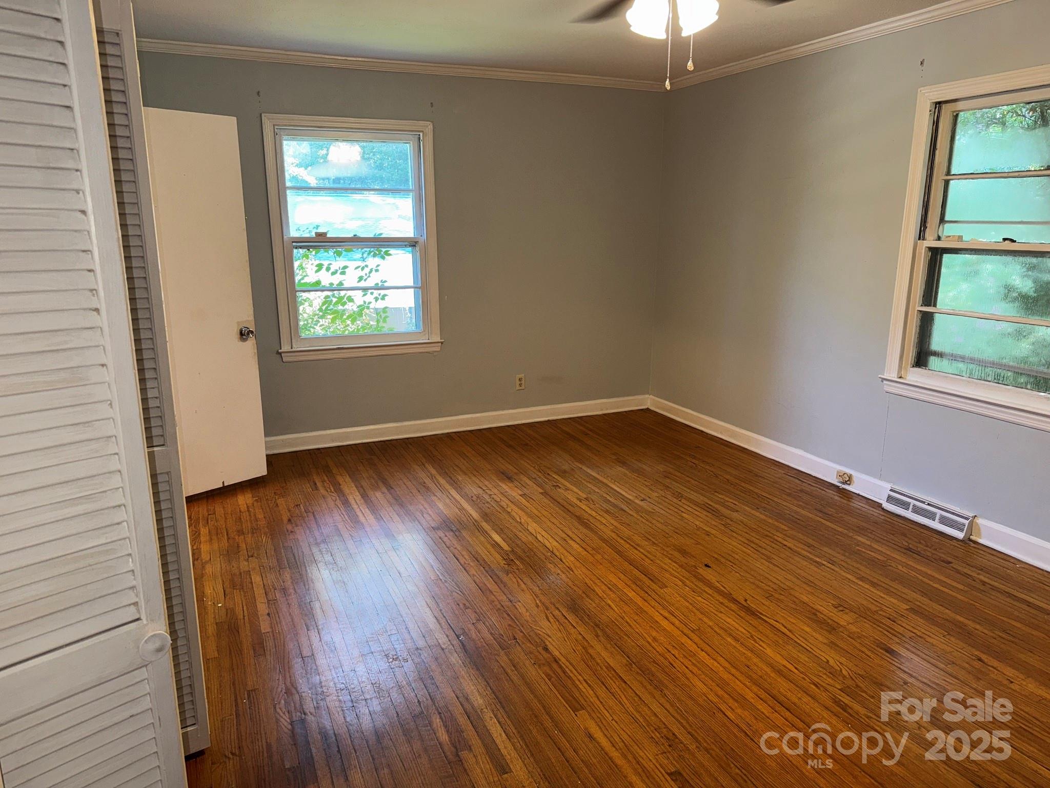 802 Roberdell Road Rockingham, NC 28379 - Photo 30 of 43 wooden floor in an empty room with a window