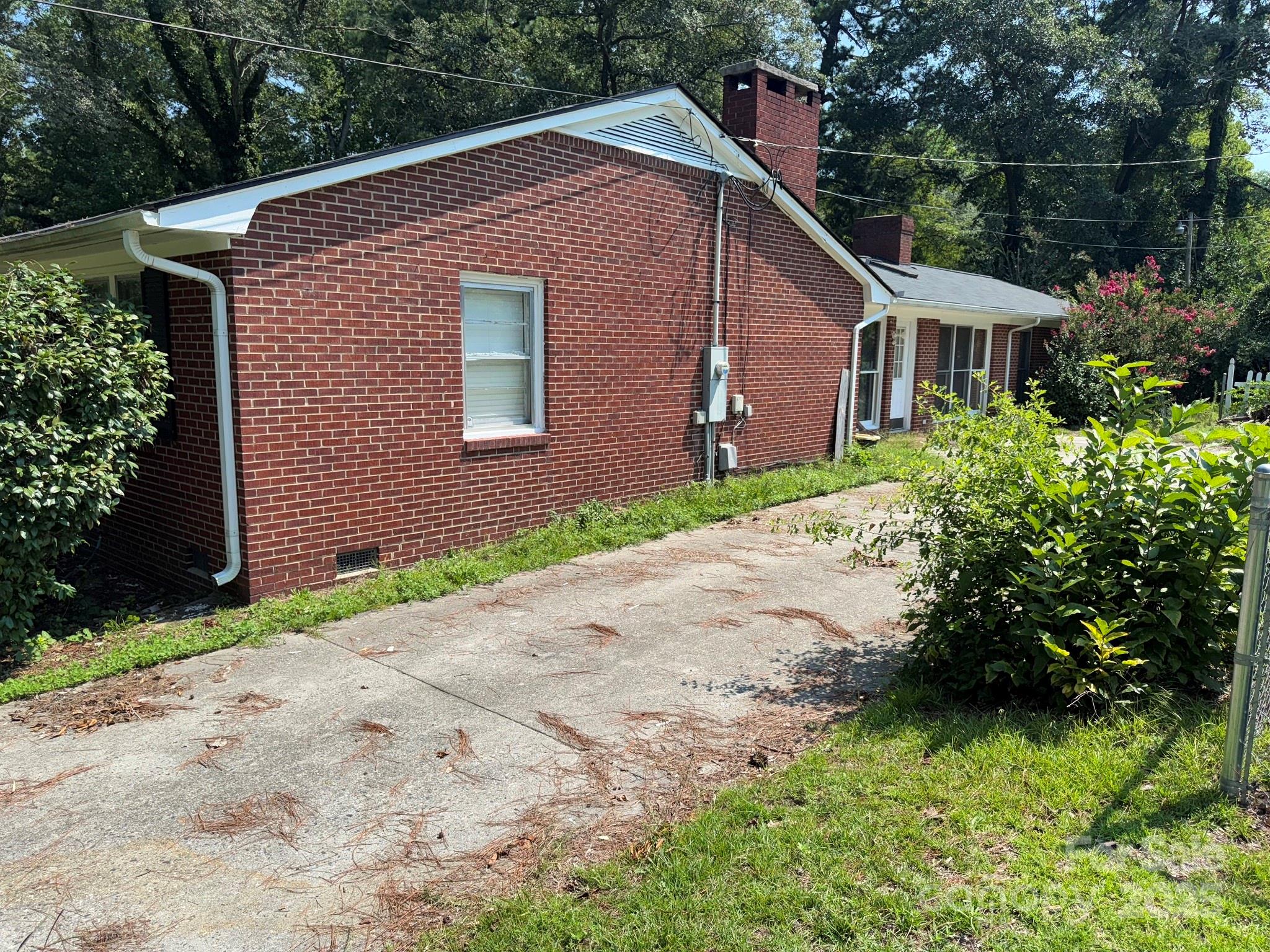 802 Roberdell Road Rockingham, NC 28379 - Photo 3 of 43 a front view of a house with a yard and garage