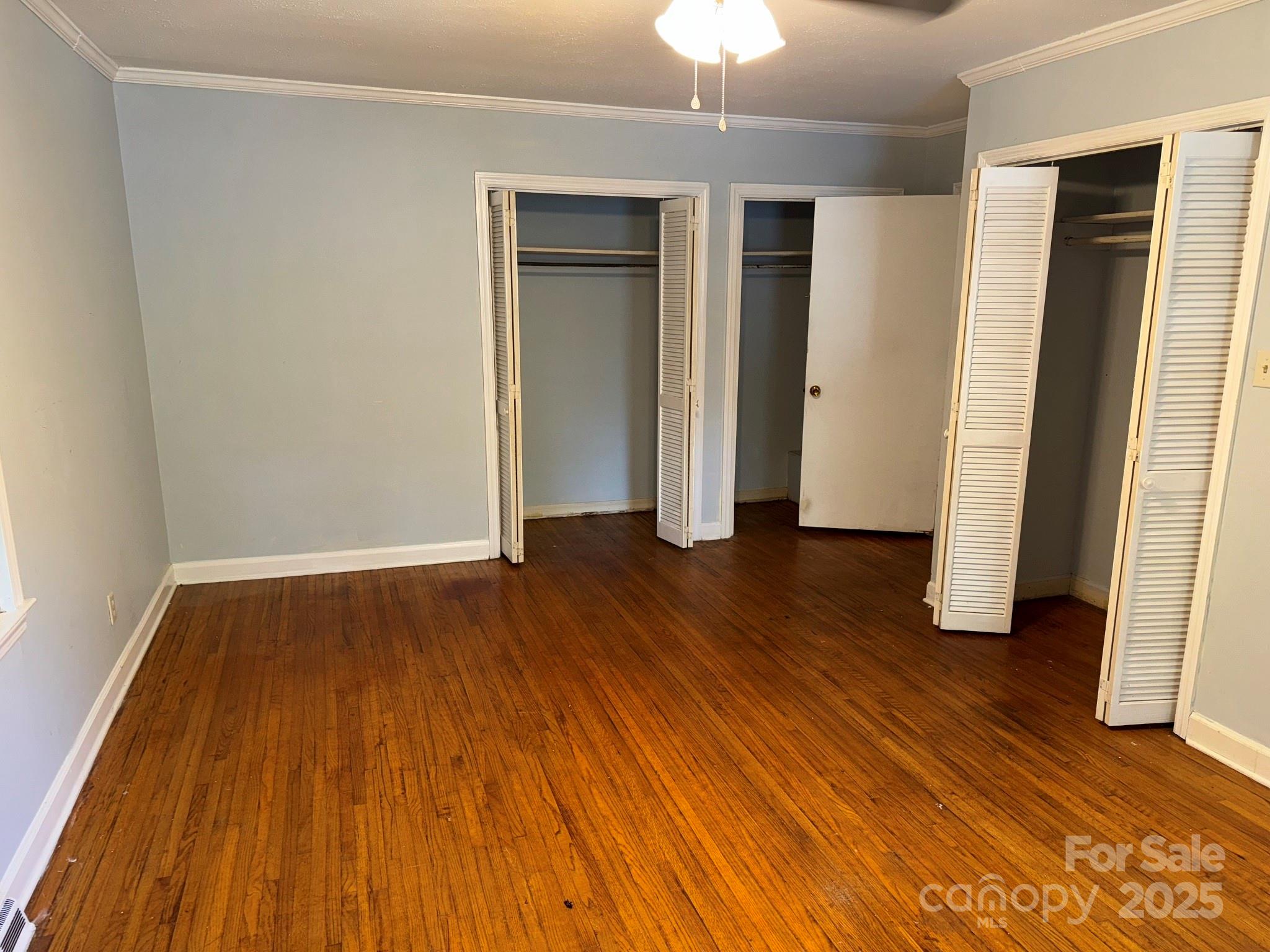802 Roberdell Road Rockingham, NC 28379 - Photo 31 of 43 an empty room with wooden floor and chandelier