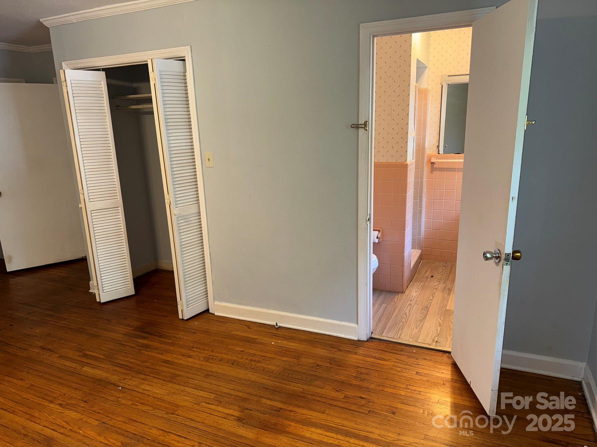 802 Roberdell Road Rockingham, NC 28379 - Photo 32 of 43 an empty room with wooden floor and closet