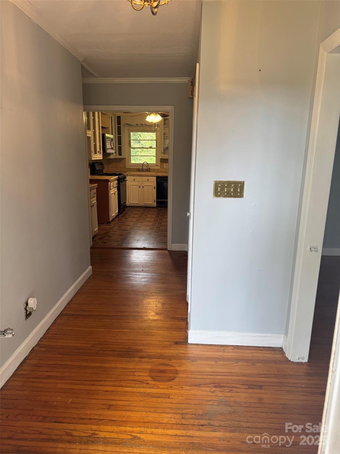 802 Roberdell Road Rockingham, NC 28379 - Photo 4 of 43 a view of a hallway with wooden floor and a living room