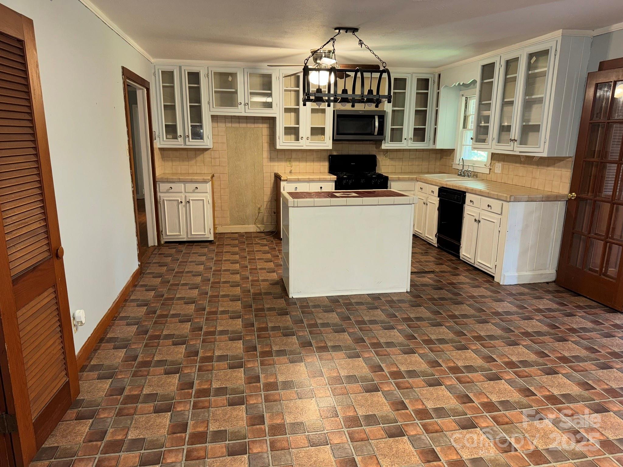 802 Roberdell Road Rockingham, NC 28379 - Photo 5 of 43 a kitchen with stainless steel appliances a stove a sink and a refrigerator