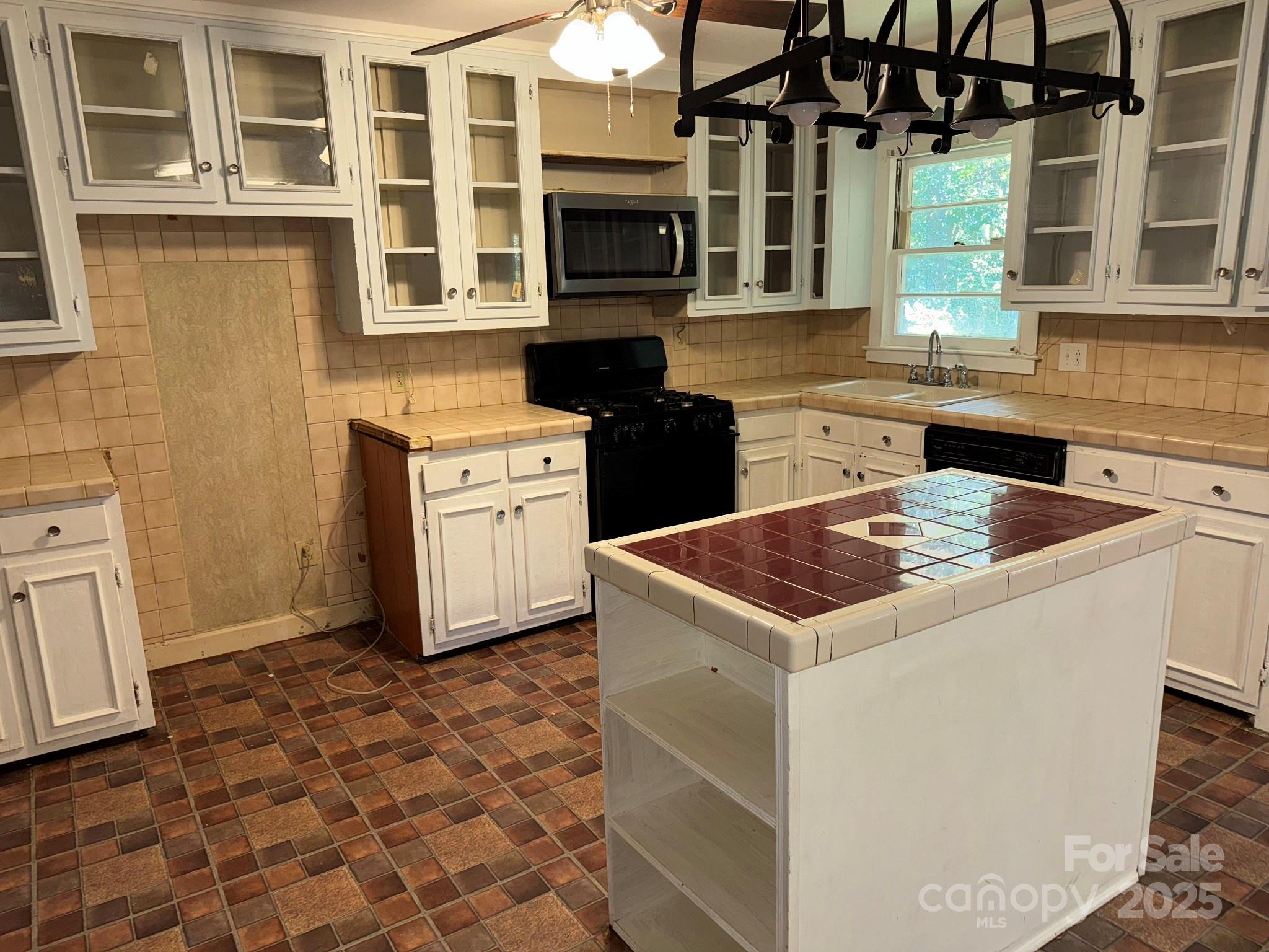802 Roberdell Road Rockingham, NC 28379 - Photo 6 of 43 a kitchen with stainless steel appliances granite countertop a stove a sink and a microwave