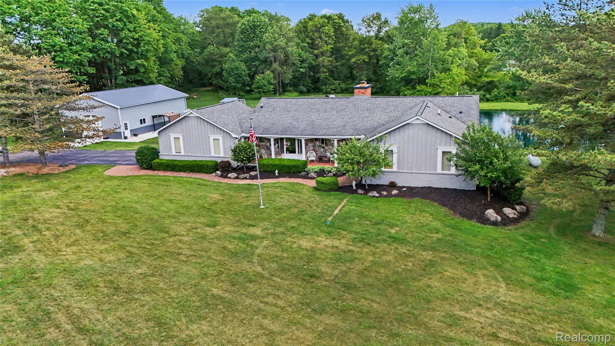 5465 South Lake George Road Metamora, MI 48455 - Photo 1 of 61 Ranch-style residence featuring a gray exterior with stone accents and a prominent front porch