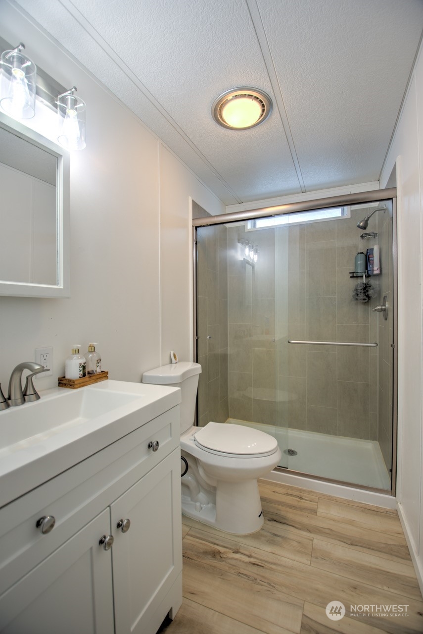 435 Jones Road Winlock, WA 98596 - Photo 14 of 30 a bathroom with a sink toilet a mirror and shower