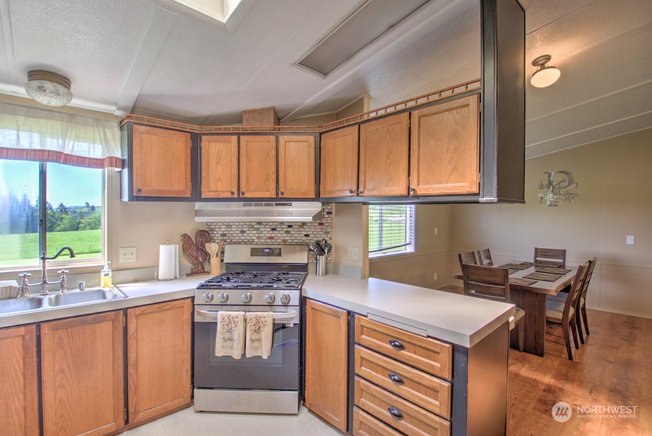 435 Jones Road Winlock, WA 98596 - Photo 5 of 30 a kitchen with stainless steel appliances granite countertop a stove a sink and a microwave