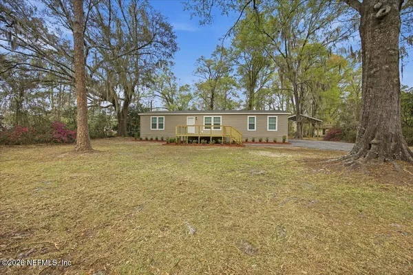 a view of house with outdoor space and swimming pool