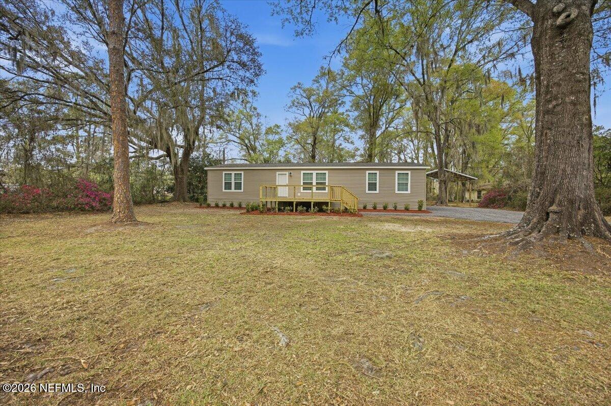 a view of house with outdoor space and swimming pool