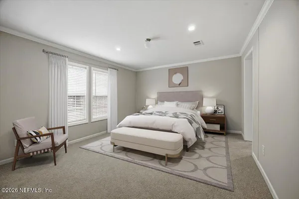 a bedroom with a bed and a couch