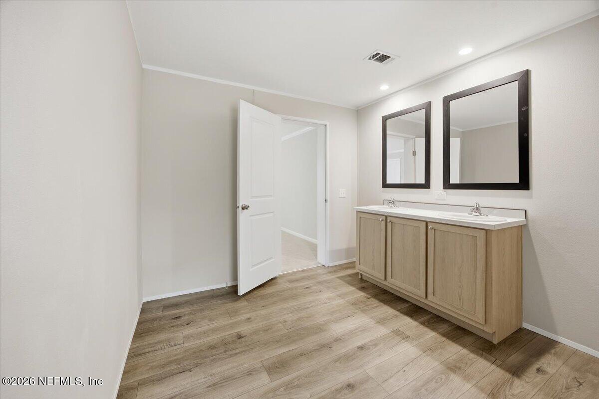 6067 Taft Road Macclenny, FL 32063 - Photo 16 of 23 a view of a hallway with bathroom and mirror