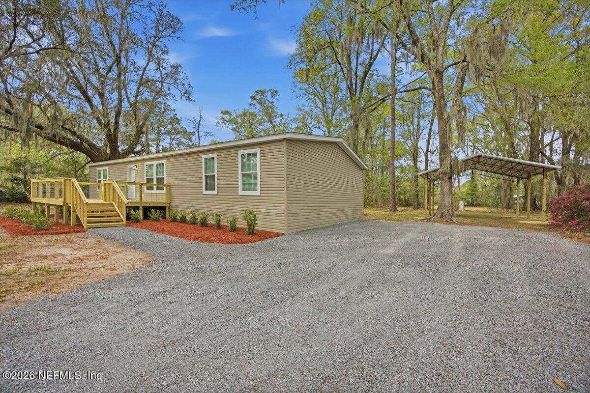 6067 Taft Road Macclenny, FL 32063 - Photo 3 of 23 a view of a house with a yard and garage