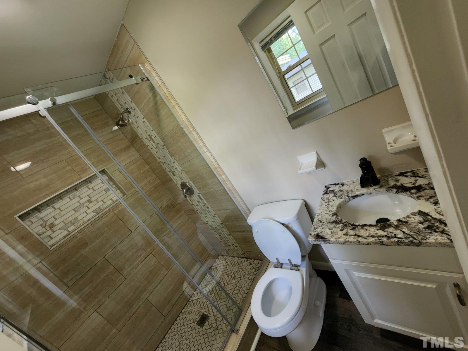 2764 Milburnie Road Raleigh, NC 27610 - Photo 8 of 39 a bathroom with a toilet and a mirror