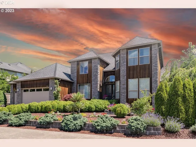 a front view of a house with a garden