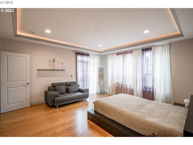 a bedroom with a bed window and couch