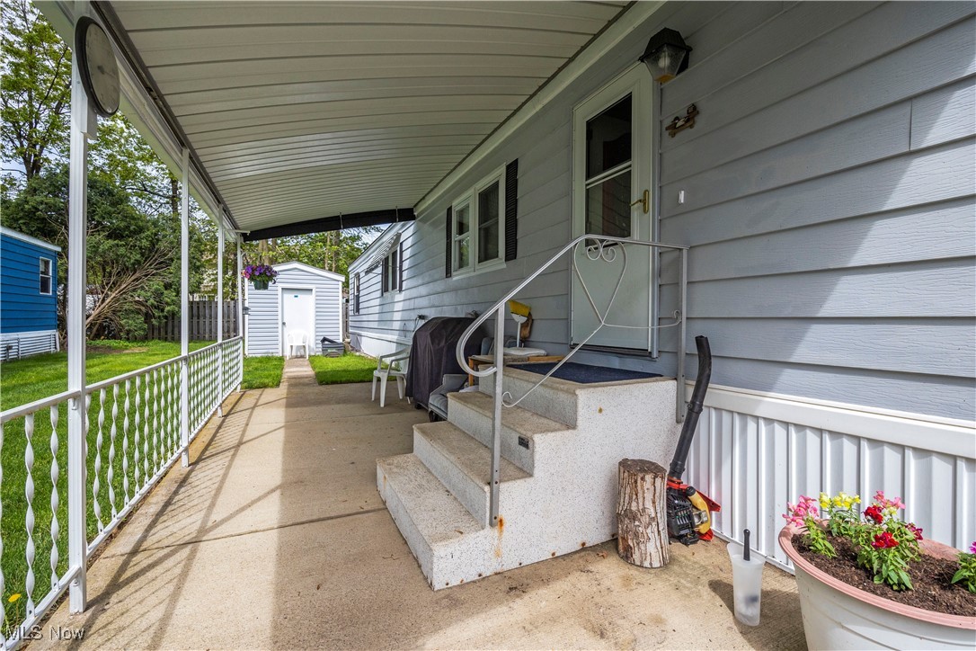 35157 Center Ridge Road, Unit 117 North Ridgeville, OH 44039 - Photo 2 of 21 View of patio with a storage shed and an outbuilding