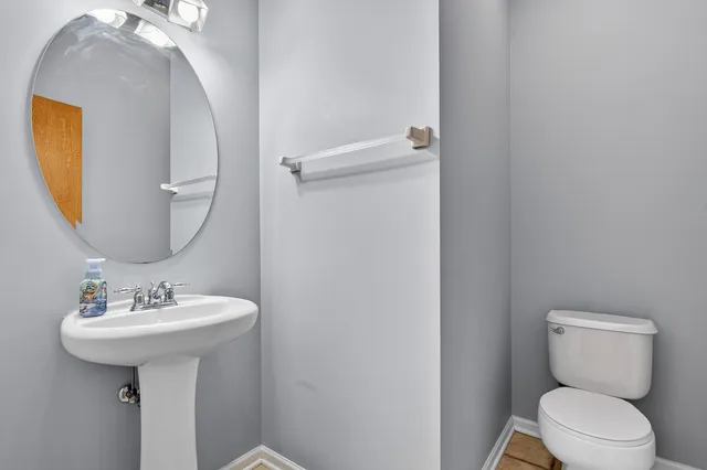 a bathroom with a sink toilet and mirror