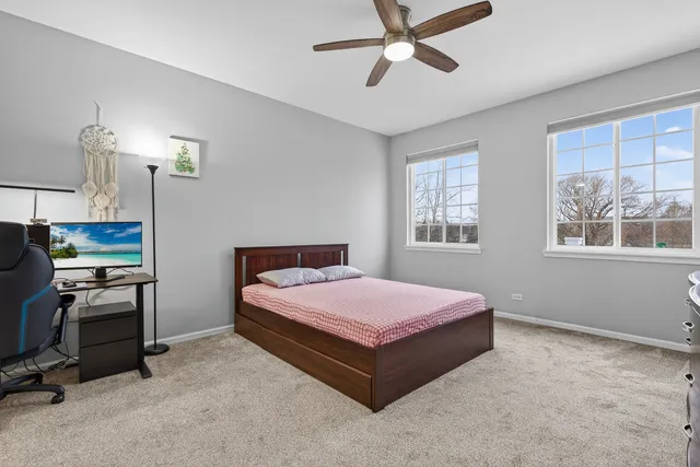 a bedroom with a bed dresser and window