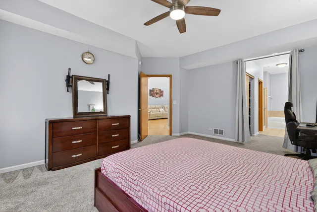 a bedroom with a bed and a dresser