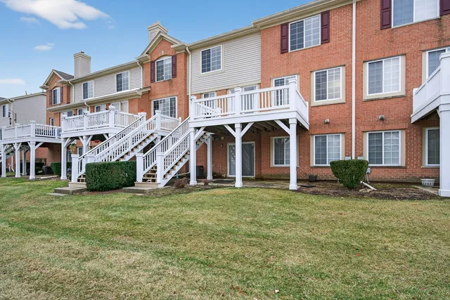 a front view of a building with a garden