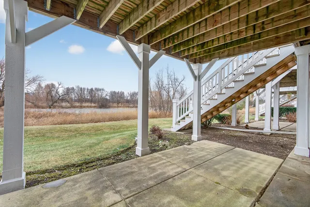 a view of porch with a floor to ceiling window and potted plants
