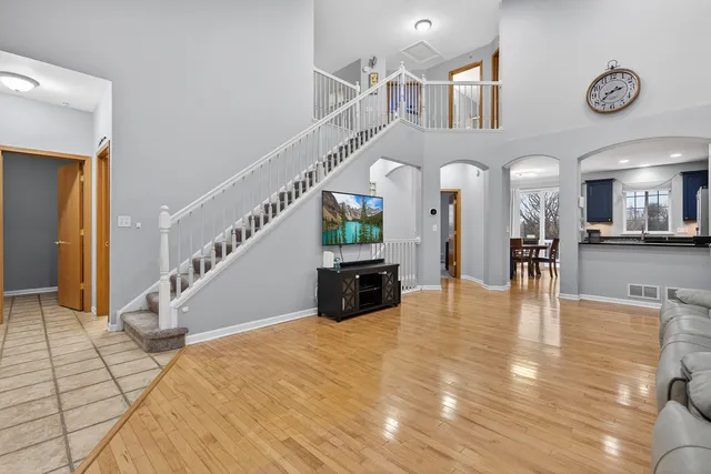 a view of entryway and hall with wooden floor