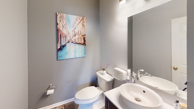 749 Lenox Avenue Bolingbrook, IL 60490 - Photo 13 of 33 a bathroom with a toilet sink and mirror