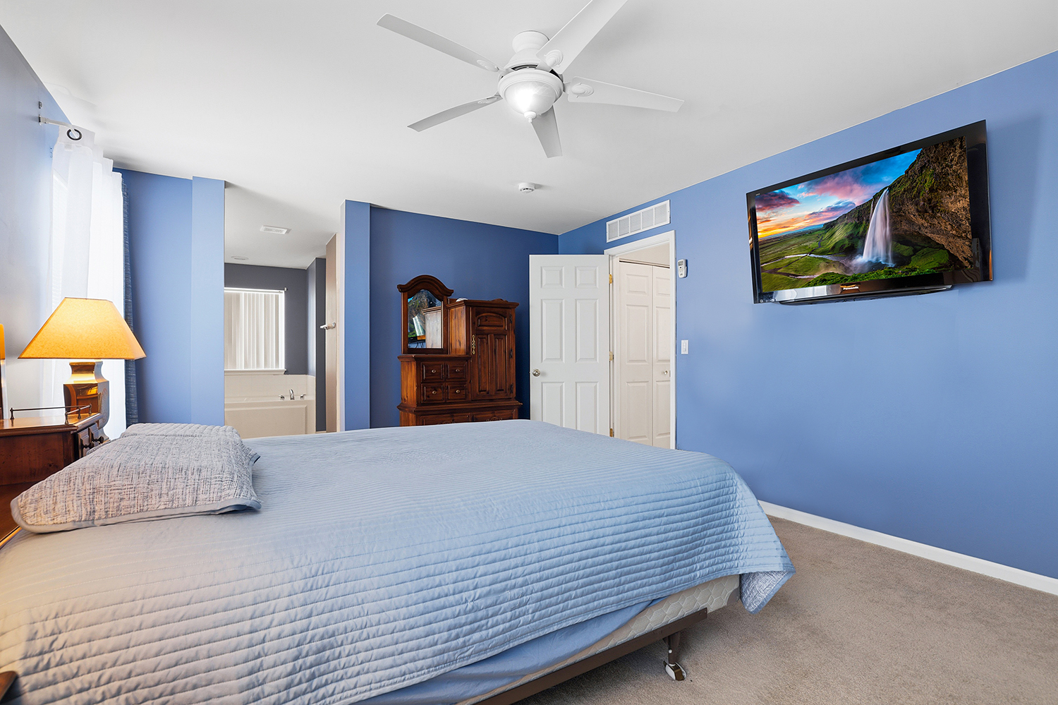749 Lenox Avenue Bolingbrook, IL 60490 - Photo 16 of 33 a bedroom with a large bed a chandelier and a window