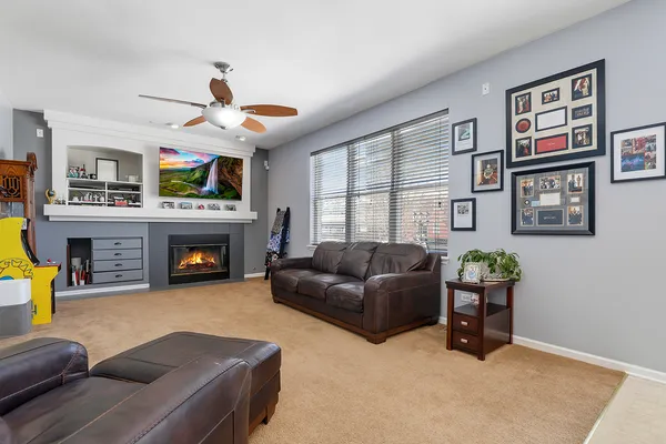 a living room with furniture a fireplace and a flat screen tv