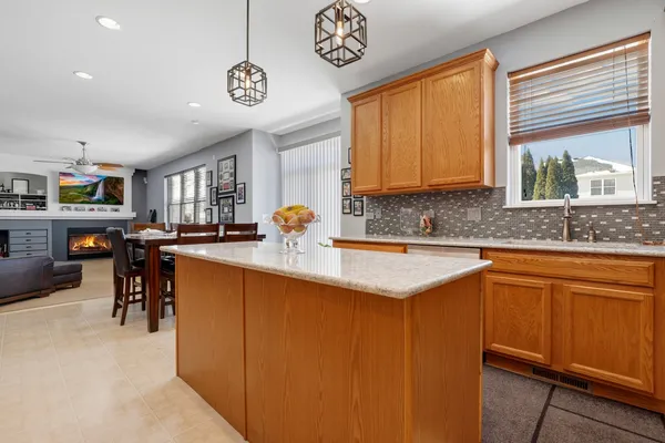 a kitchen with stainless steel appliances granite countertop a sink a stove and a refrigerator