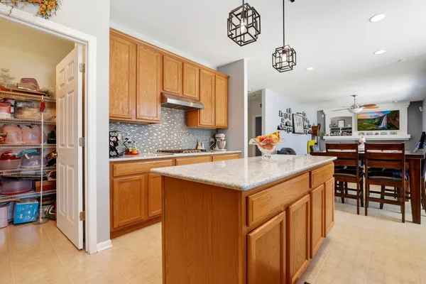 a kitchen with stainless steel appliances granite countertop a sink and cabinets