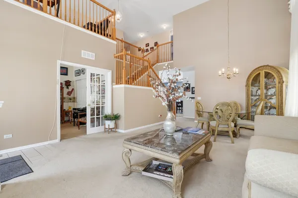 a view of a dining room with furniture and chandelier