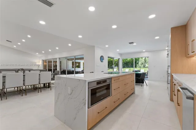 a large kitchen with lots of counter space and stainless steel appliances